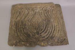 A LARGE 17TH CENTURY INDIAN DECCANI CARVED STONE PANEL, depicting a lotus flower, 59cm x 49cm.