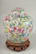 A CHINESE MILLEFLEURS FAMILLE ROSE PORCELAIN JAR AND COVER, base with character mark, 20cm high.