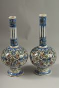A FINE PAIR OF 19TH CENTURY PERSIAN QAJAR GLAZED POTTERY BOTTLE VASES, 32cm high.