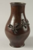 A 19TH CENTURY CHINESE BRONZE VASE, with raised chilong decoration, 28cm high.