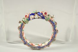 A VERY FINE 19TH CENTURY INDIAN ENAMELLED SILVER BANGLE, with two elephant heads, inset with red