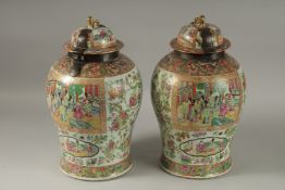 A GOOD PAIR OF 18TH CENTURY CANTON ENAMELLED GINGER JARS AND COVERS, with metal mounts, painted with