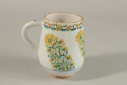 A TURKISH KUTAHYA GLAZED POTTERY MUG.