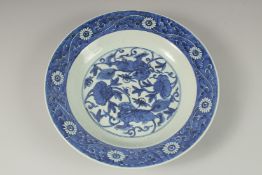 A CHINESE BLUE AND WHITE PORCELAIN CHARGER, painted with central floral panel depicting two lion