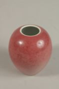 A CHINESE COPPER RED PORCELAIN BRUSH POT, with four-character mark, (af), 8cm.