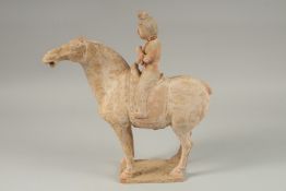 A TANG POTTERY HORSE AND RIDER, 32cm high.