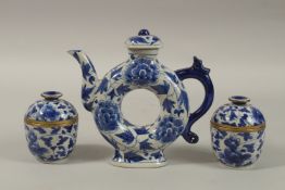 A CHINESE BLUE AND WHITE PORCELAIN PIERCED CENTRE TEAPOT, together with associated pair of lidded