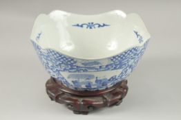 A CHINESE BLUE AND WHITE PORCELAIN SQUARE FORM BOWL AND HARDWOOD STAND, the bowl with panels of
