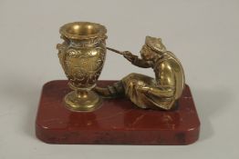 A CHINESE BRASS GROUP OF A MAN PAINTING A VASE, mounted to a rectangular red marble base, 13cm x 8cm
