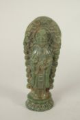 A GREEN SOAPSTONE FIGURE OF GUANYIN, 17cms high.