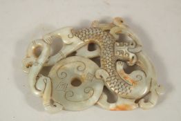 A CARVED JADE AMULET, 10cms x 8cms.