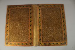 A 19TH CENTURY INDIAN KASHMIR LACQUERED BOOK BINDING, 34.5cm x 26cm.
