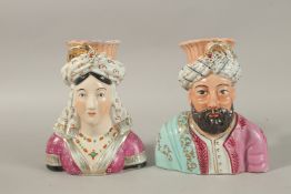 A PAIR OF FRENCH OTTOMAN MARKET SULTAN AND SULTANE PORCELAIN FIGURAL VASES, 23cm high.