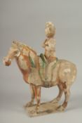 A TANG POTTERY HORSE AND RIDER, 32cm high.