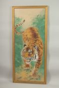 A LARGE PAINTING ON SILK OF A TIGER, framed and glazed, 107cm x 47.5cm overall.