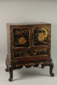 A FINE JAPANESE MEIJI PERIOD BLACK AND GILT LACQUERED CABINET, raised on stand, the two doors