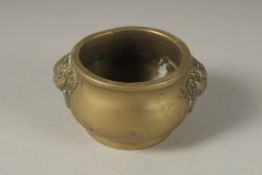 A MINIATURE 18TH CENTURY BRONZE CENSER, with lion ring handles, 5cm diameter.