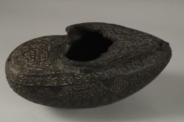A SUPERB EXTENSIVELY CARVED COCO DE MER, with Islamic calligraphy, 30cm long, 14cm wide, 11cm deep.