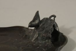 A SIGNED JAPANESE BRONZE TRAY, the corner with an okimono of a bird on a leaf, signed to base,