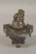 A CHINESE CARVED AGATE TRIPOD KORO AND COVER, with twin drop-ring handles and carved foo dog finial,