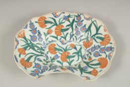 A TURKISH GLAZED POTTERY SHAVING PLATE, 28cm wide.