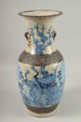 A CHINESE BLUE AND WHITE PORCELAIN VASE, painted with peacocks and flora, with molded naturalistic
