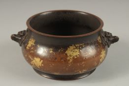 A CHINESE GOLD SPLASH BRONZE TWIN HANDLE CENSER, the base with character mark, 19cm wide handle to
