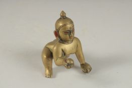 A FINE 18TH CENTURY SOUTH INDIAN BENGAL BRASS FIGURE OF CRAWLING KRISHNA, with red lacquer pigments,