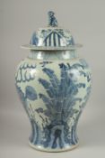 A LARGE CHINESE BLUE AND WHITE PORCELAIN BALUSTER FORM URN AND COVER, painted with mythical beasts