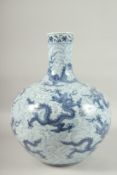 A LARGE CHINESE BLUE AND WHITE PORCELAIN DRAGON BULBOUS VASE, with multiple dragons of a wave