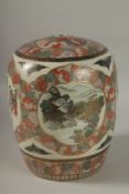 A LARGE JAPANESE SATSUMA JAR AND COVER, painted with panels of figures and landscape scenes with