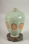 A CHINESE LONGQUN WARE PORCELAIN VASE ON A HARDWOOD STAND, with carved panels of immortals, vase