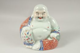 A LARGE CHINESE PORCELAIN SEATED SMILING BUDDHA, his robes painted with brickwork pattern and