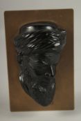 A FINE EARLY 20TH CENTURY POSSIBLY BAKELITE OR CHERRY AMBER HEAD OF AN ARAB MAN, mounted on a