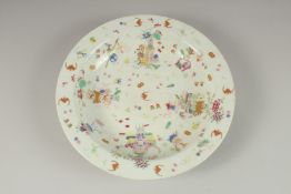 A CHINESE POLYCHROME PORCELAIN PLATE, painted with colourful enamels depicting precious objects,