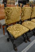 An unusual set of Italian carved oak and upholstered dining chairs.