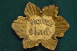 A small metal dish 'Victory Copper'.