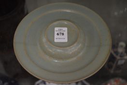 A Chinese celadon glazed circular stand.