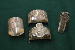 Cast silver and other napkin rings.