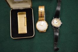 Two wristwatches and a boxed lighter.