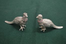 A pair of decorative silver plated pheasant salt and peppers.