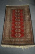 A small Bokhara style rug, 128cm x 81cm.