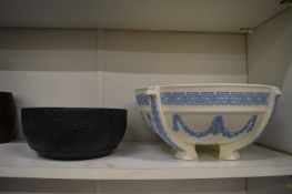 A Wedgwood black basalt jasperware bowl and a Wedgwood cream ware bowl with blue sprig decoration.