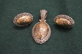 Silver earrings and a pendant.