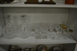 A pair of cut glass decanters and other glassware.