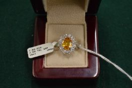 A good 18ct white gold yellow sapphire and diamond cluster ring.