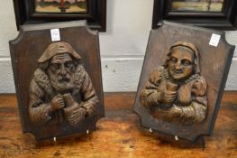 A good pair of carved figural wall plaques depicting busts of a man and a woman.