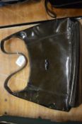 A Longchamp brown patent leather handbag.