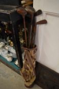 An old golf bag and clubs.