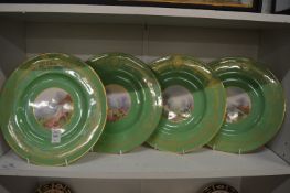 A set of four Worcester circular cabinets plates, the centres decorated with cottage gardens.